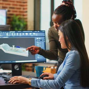 Female engineers analyzing clamp component prototype